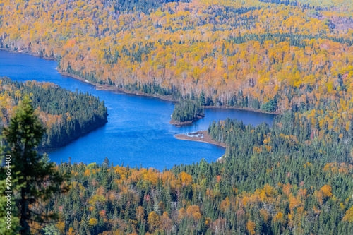 A lake in the forest in Canada, during the Indian summer, beautiful colors of the trees, panorama photo