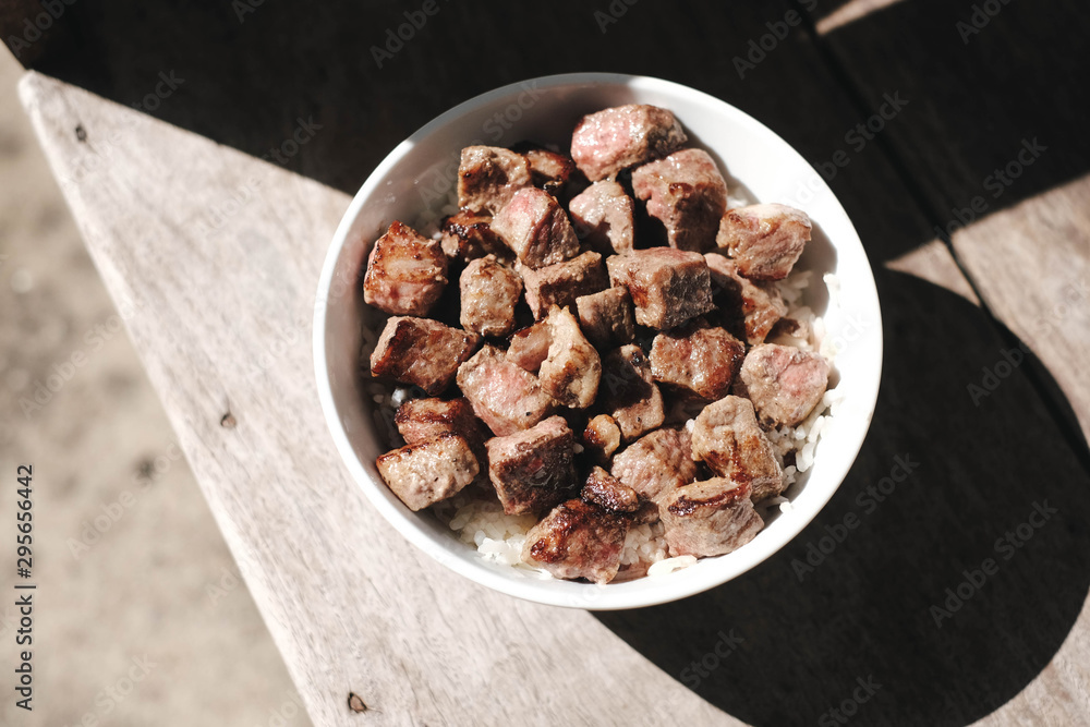 Homemade Bowl of Diced Beef Steak with rice Japanese style on wooden table. Homemade Bowl of Diced Beef Steak with rice Japanese style on wooden table.