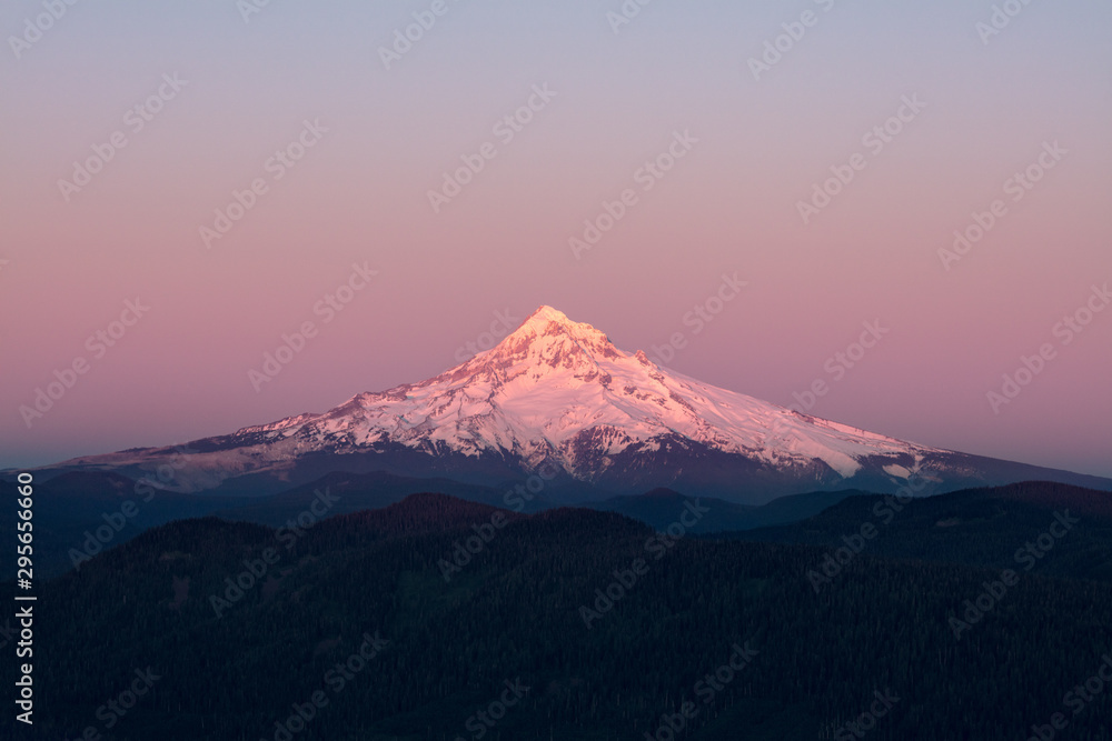 Mount Hood Covered in Snow, active stratovolcano and highest mountain in Oregon. Panoramic View from Sherrard Point, Fire Lookout at the top of Larch Mountain. Sunset, Purple Sky,  Glowing Summit