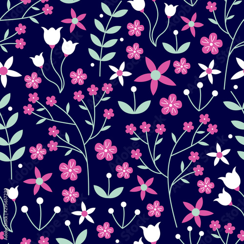 Vector seamless pattern of mixed flowers, laurels, leaves in hot pink, white and mint green on a dark navy blue background. Great for dressmaking fabric, bedroom decor and wallpaper.