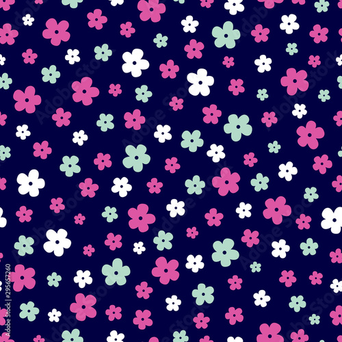 Vector seamless pattern of small ditsy print flowers in hot pink, white and mint green on a dark navy blue background. Great for dressmaking fabric, bedroom decor and wallpaper.