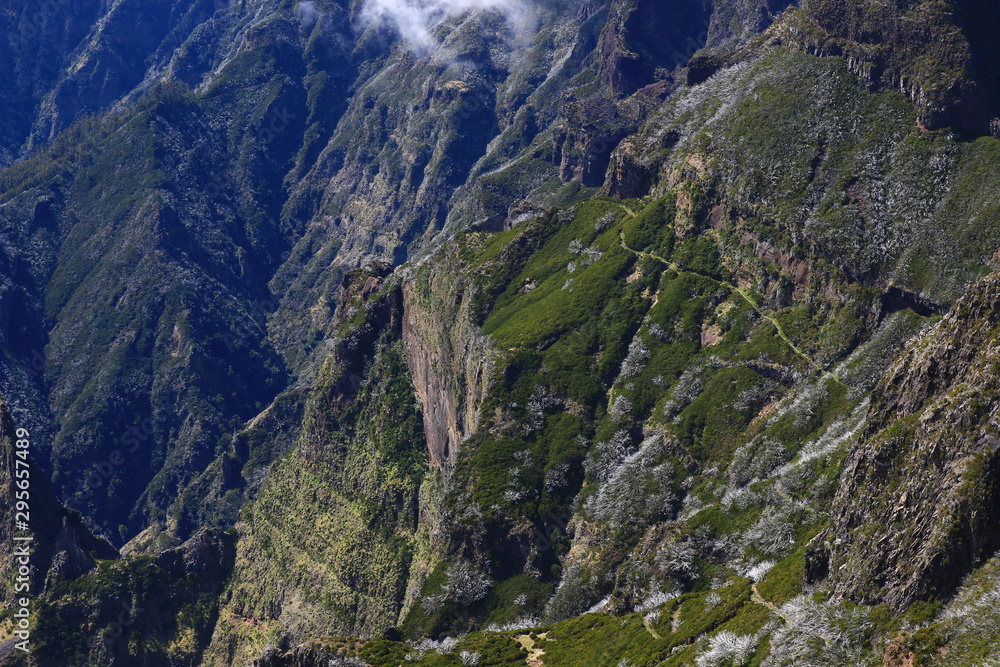A dramatic view of the hiking trail connecting Pico Arieiro and Pico Ruivo (Madeira island, Portugal) A dramatic view of the hiking trail connecting Pico Arieiro and Pico Ruivo (Madeira island, Portugal)