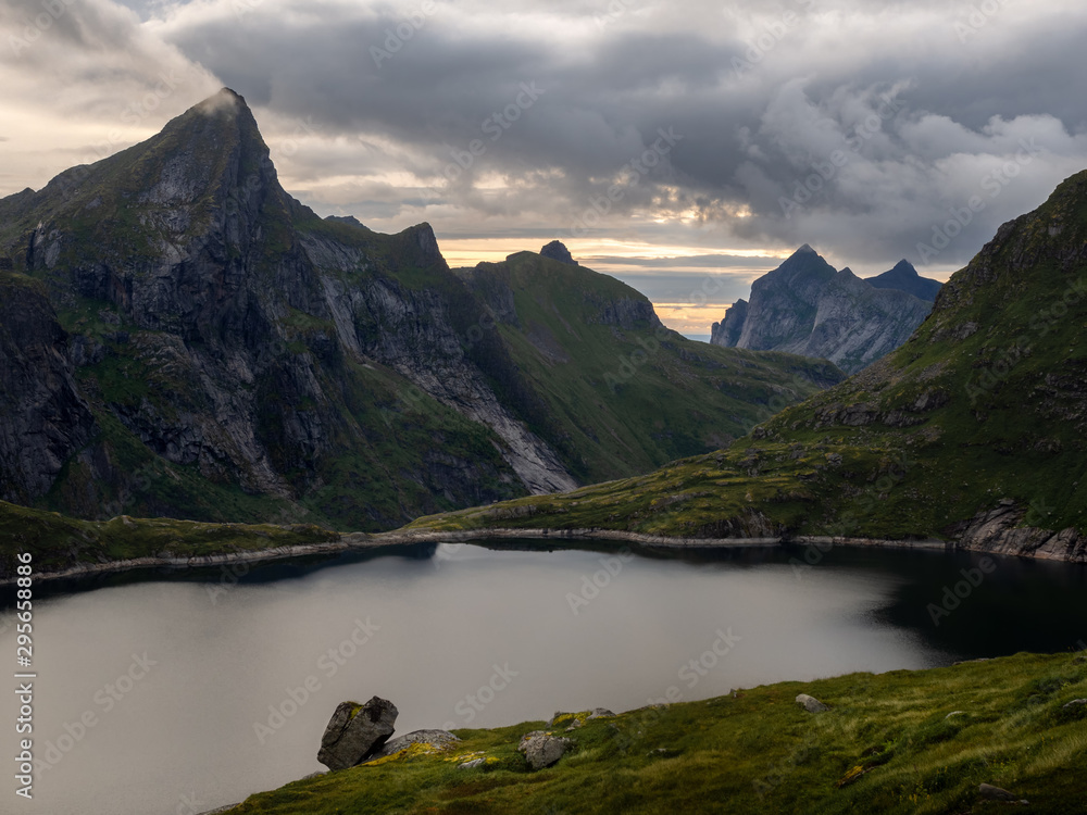 A mountain lake surrounded by peaks in the Norwegian area of Lofoten A mountain lake surrounded by peaks in the Norwegian area of Lofoten