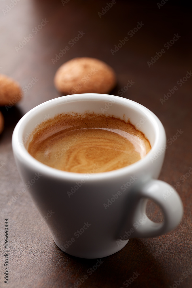 Cup of coffee with amaretti (Italian biscuits) on rustic wooden background. Close up. Cup of coffee with amaretti (Italian biscuits) on rustic wooden background. Close up.