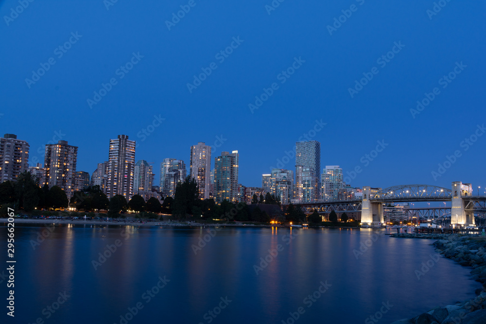 Vancouver downtown with Burrard Street Bridge and Sunset Beach Park at dusk, Canada