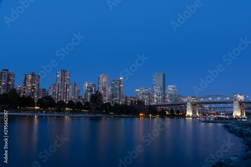 Vancouver downtown with Burrard Street Bridge and Sunset Beach Park at dusk, Canada