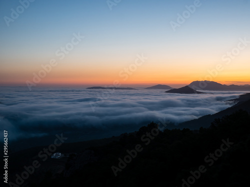  wooded landscape with clouds of mists below © Miguel Fernandez