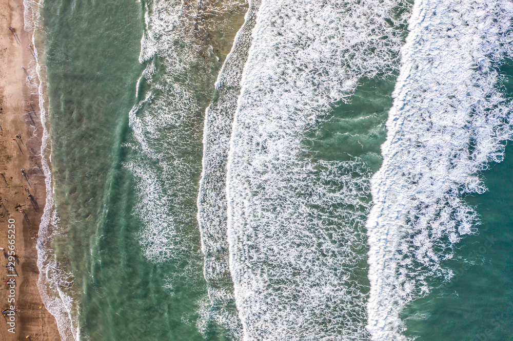 Aerial view of sandy beach with tourists swimming in beautiful clear sea water Aerial view of sandy beach with tourists swimming in beautiful clear sea water