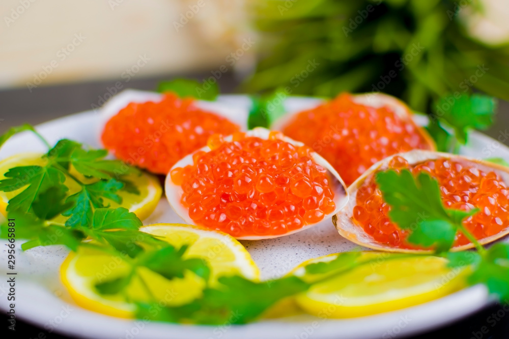 red caviar and seafood with lemon and herbs, seafood dish, delicacy. close-up, selective focus red caviar and seafood with lemon and herbs, seafood dish, delicacy. close-up, selective focus