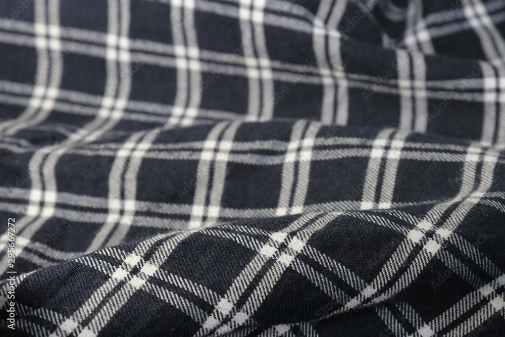 The background plaid fabric with wrinkles. The background plaid fabric with wrinkles.