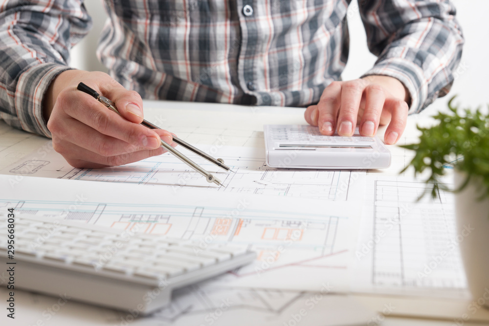 Architects working on blueprint, real estate project. Architect workplace. Construction concept. Engineering tools. Architects working on blueprint, real estate project. Architect workplace. Construction concept. Engineering tools.