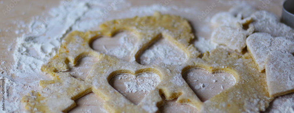 the dough for the shortbread in a heart shape on cutting Board the dough for the shortbread in a heart shape on cutting Board
