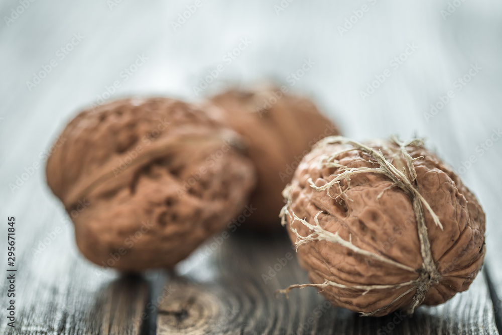 Walnut lies on a wooden background , close-up . Walnut lies on a wooden background , close-up .