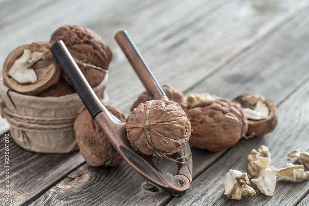 Organic Walnut lies on a wooden background , close-up . Organic Walnut lies on a wooden background , close-up .