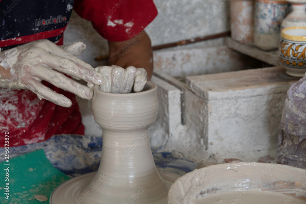 Close-up motion of hands making large ceramic vase