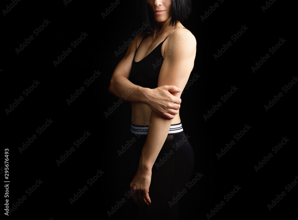 Naklejka premium Adult girl with a sports figure in black bra and black 