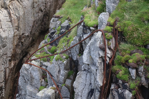 Rusty Steel Ropes on Cliff Face