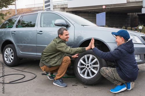 фотографія Father and son are repairing a car
