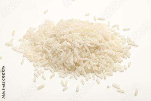 handful of white rice on a white table