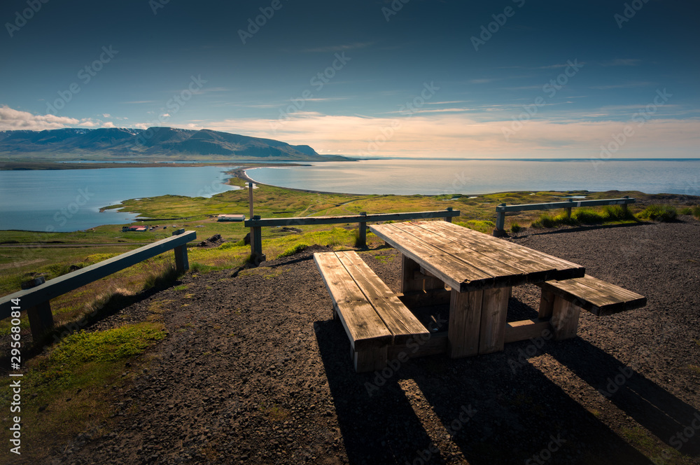 Wooden bench on the ocean shore to mountain beautiful view