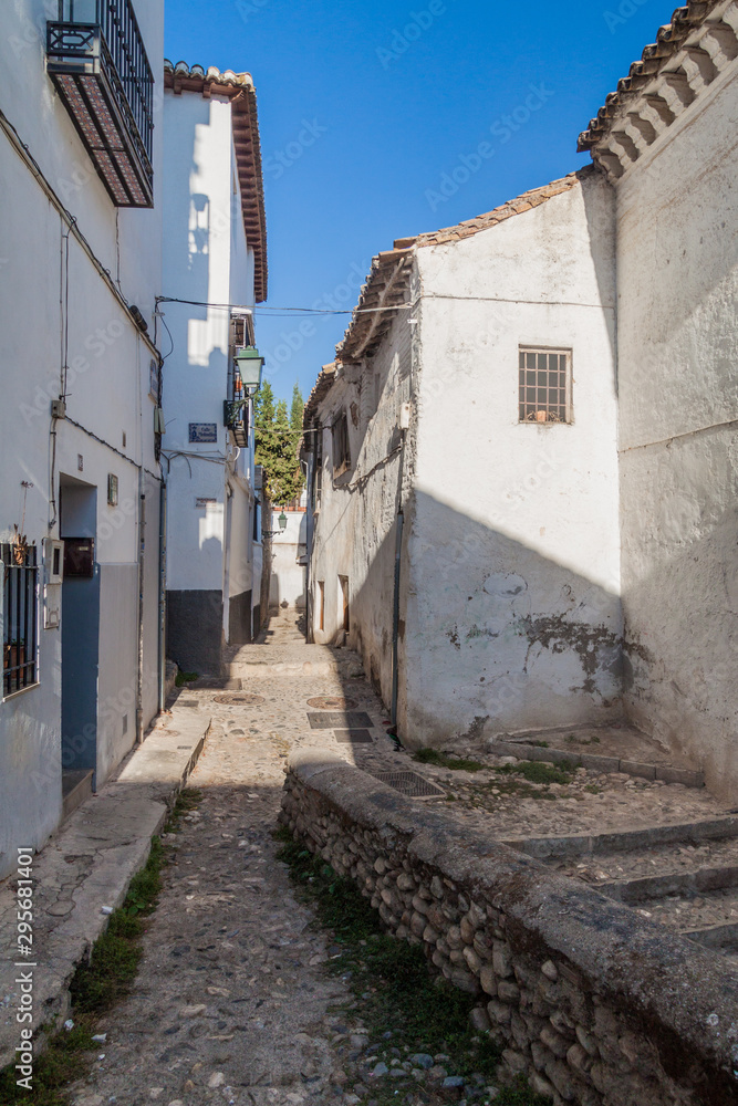 Narrow street in Albaycin neighborhood of Granada, Spain
