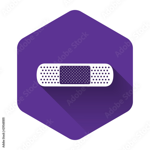 White Bandage plaster icon isolated with long shadow. Medical plaster, adhesive bandage, flexible fabric bandage. Purple hexagon button. Vector Illustration