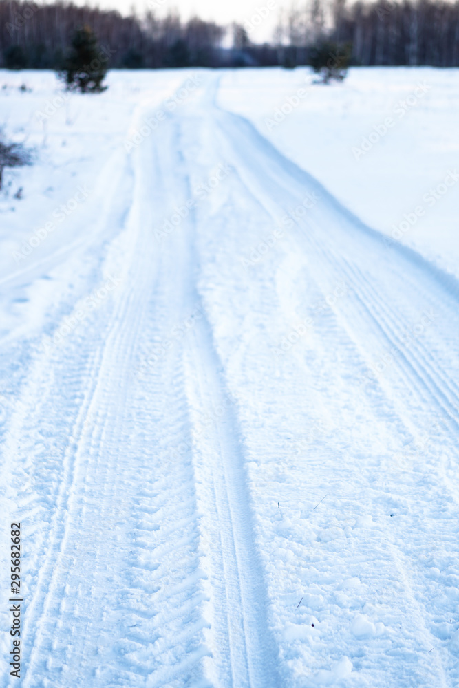 Tread texture of car wheels on snow. Winter road in January, December. Rural area and background of tractor tracks in the snow Tread texture of car wheels on snow. Winter road in January, December. Rural area and background of tractor tracks in the snow