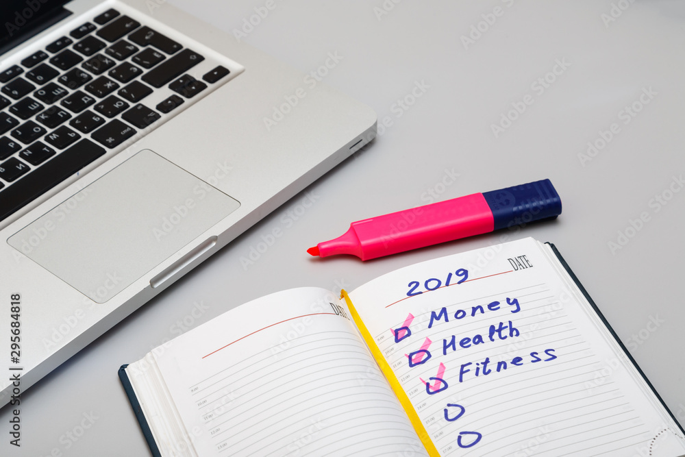 Opened daily organizer with with complete task on the grey background Opened daily organizer with with complete task on the grey background