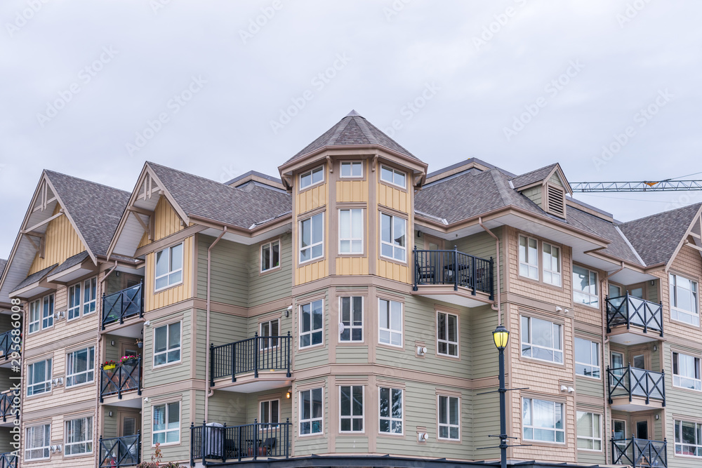 The top of an apartment building with nice windows. The top of an apartment building with nice windows.