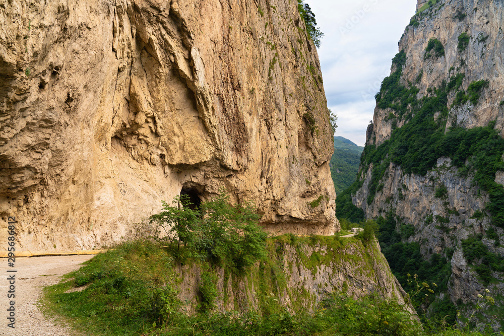 beautiful mountain landscape sheer cliff and cave entrance