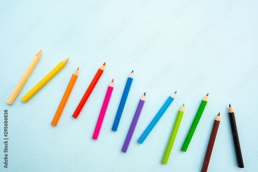 Top view of colourful crayons or colour pencil set in range isolated on pastel indigo blue background.Education,Business office and Arts Concept.Copy space empty blank for text.Back to school Top view of colourful crayons or colour pencil set in range isolated on pastel indigo blue background.Education,Business office and Arts Concept.Copy space empty blank for text.Back to school