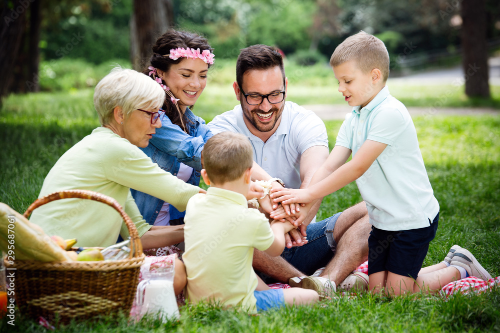 Multi generation family enjoying picnic in a park Multi generation family enjoying picnic in a park