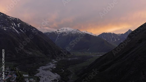 Sunset in Mountains in Georgia Kazbegi and Gergeti Trinity Church north Caucasus drone flight photo