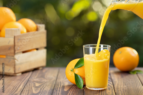 orange juice pouring in glass