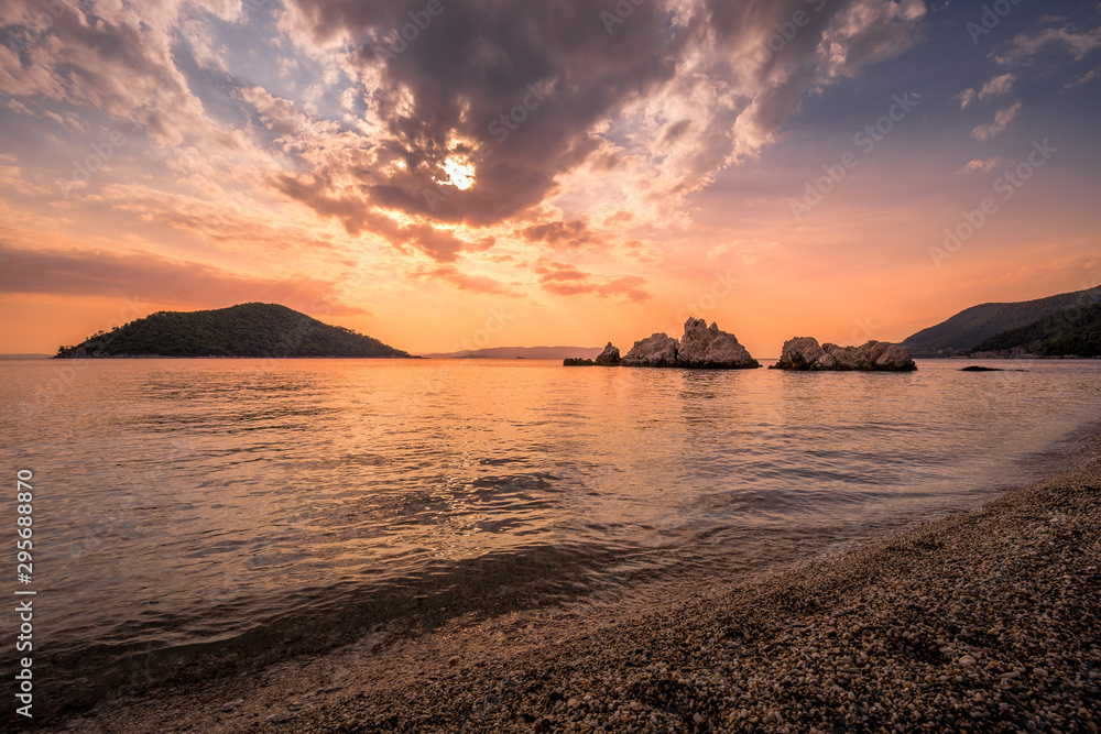 Dramatic sunset at the beach at Skopelos island in Greece.