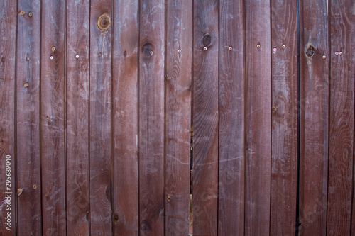 Wood texture. Vertical wooden boards, fence. The dark paint.