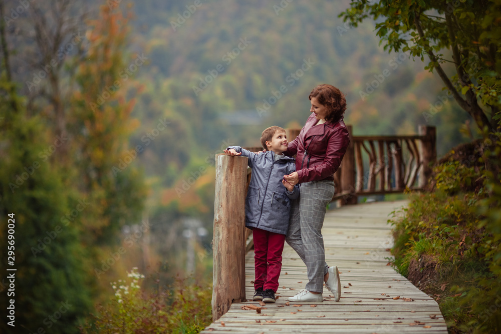 Travelers mother son in the autumn mountains for a walk. Travelers mother son in the autumn mountains for a walk.