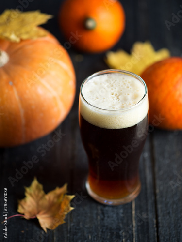 A glass of traditional pumpkin beer ale on a wooden table