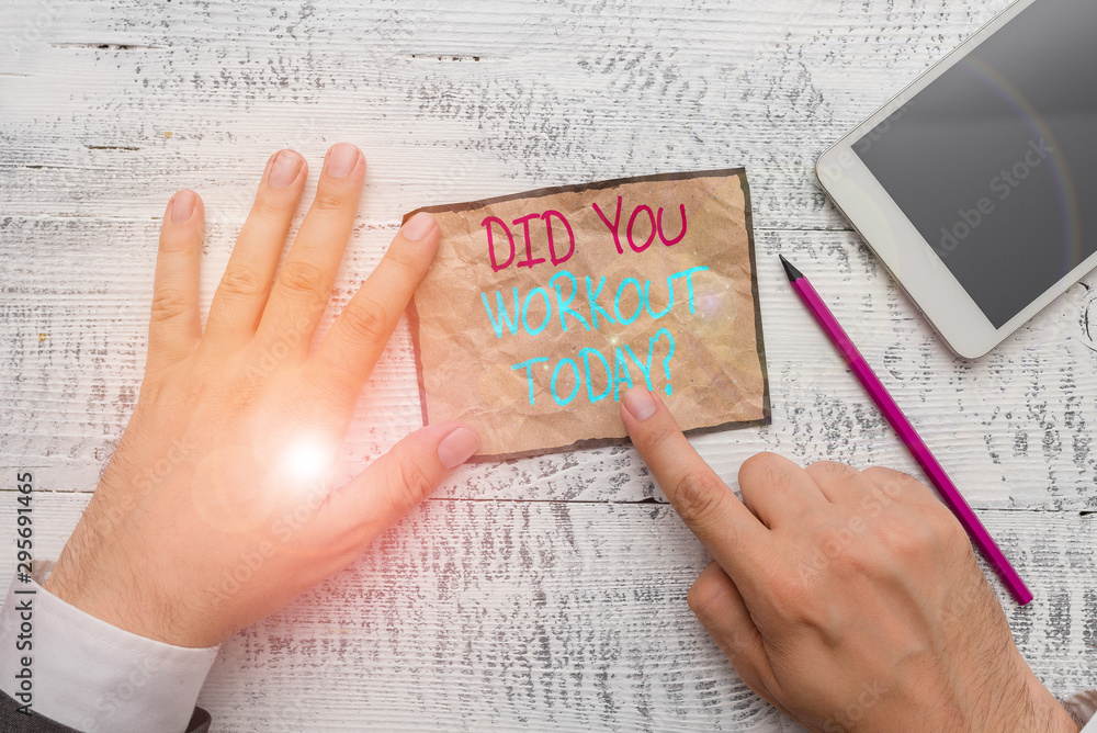 Obraz premium Handwriting text writing Did You Workout Today. Conceptual photo asking if made session physical exercise Hand hold note paper near writing equipment and modern smartphone device