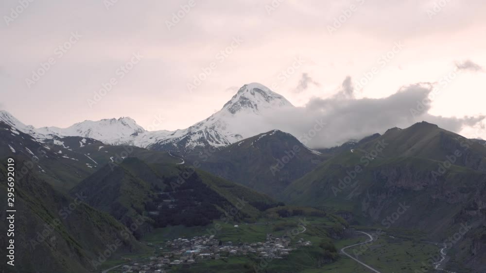 Sunset in Mountains in Georgia Kazbegi and Gergeti Trinity Church north Caucasus drone flight Sunset in Mountains in Georgia Kazbegi and Gergeti Trinity Church north Caucasus drone flight