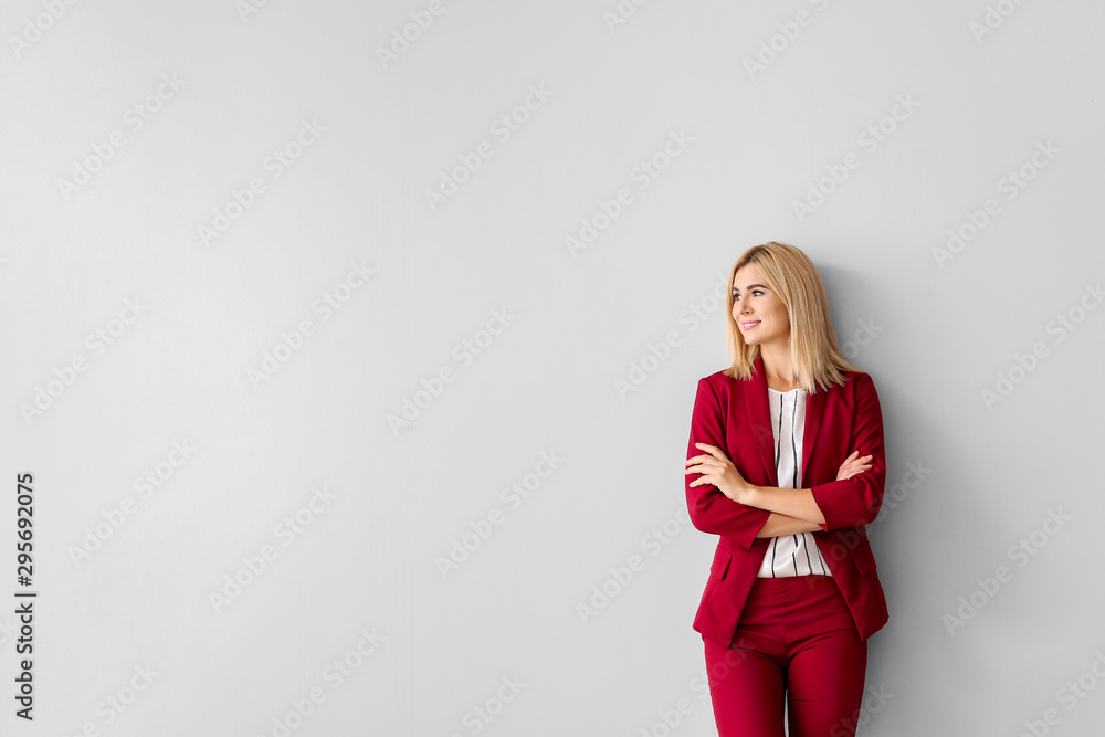 Beautiful stylish businesswoman on light background - obrazy, fototapety, plakaty 