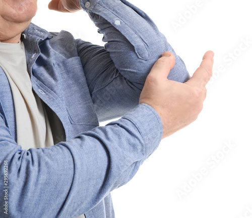 Senior man suffering from pain in elbow on white background, closeup