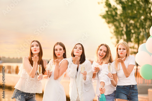 Beautiful young women drink...