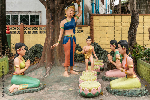 Bang Saen, Thailand - March 16, 2019: Wang Saensuk Buddhist Monastery. Group of colorful sculptures depicting the child Buddha, Sirimahamaya his mother and adoring women.