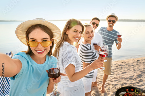 Friends taking selfie at ba...