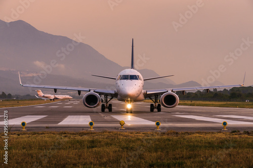 Sunset view of Airport of Tivat, Montenegro, with take-off planes.