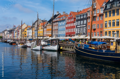 Famous Nyhavn pier with colorful facades of old houses and vintage ships in Copenhagen  capital of Denmark. Summertime in the fantastic city of Copenhagen