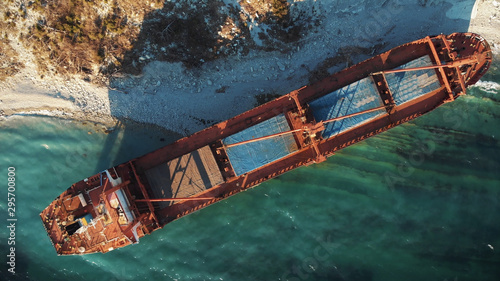 Cargo ship run aground at sea coastline near Novorossiysk and Gelendzhik. Shipwreck accident of nautical vessel after huge sea storm, aerial view from drone