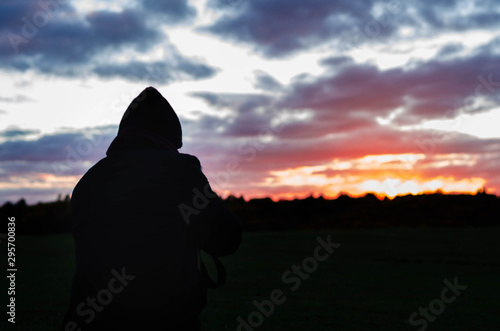  boy photographing a sunset