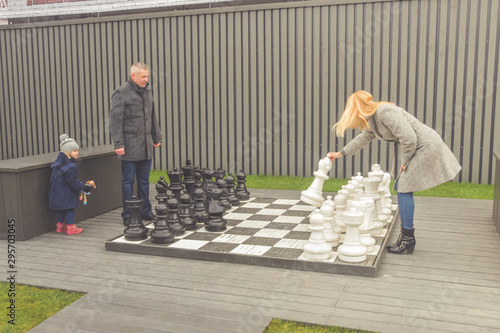 family baby dad mom Playground play autumn outside chess